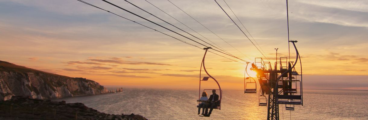 People on the chairlift whilst the sun is setting